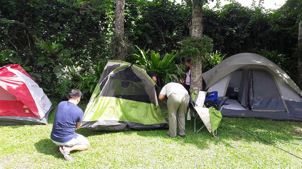 pitching tents, setting up mattresses and white linen beddings